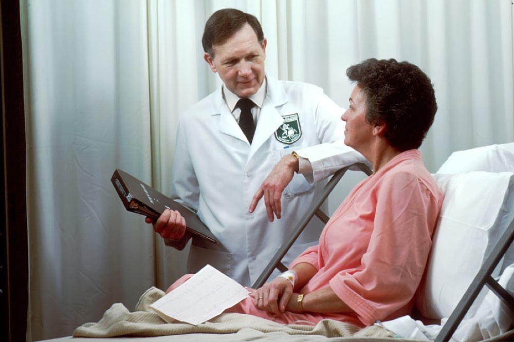 Physician checking on a patient at the hospital bedside